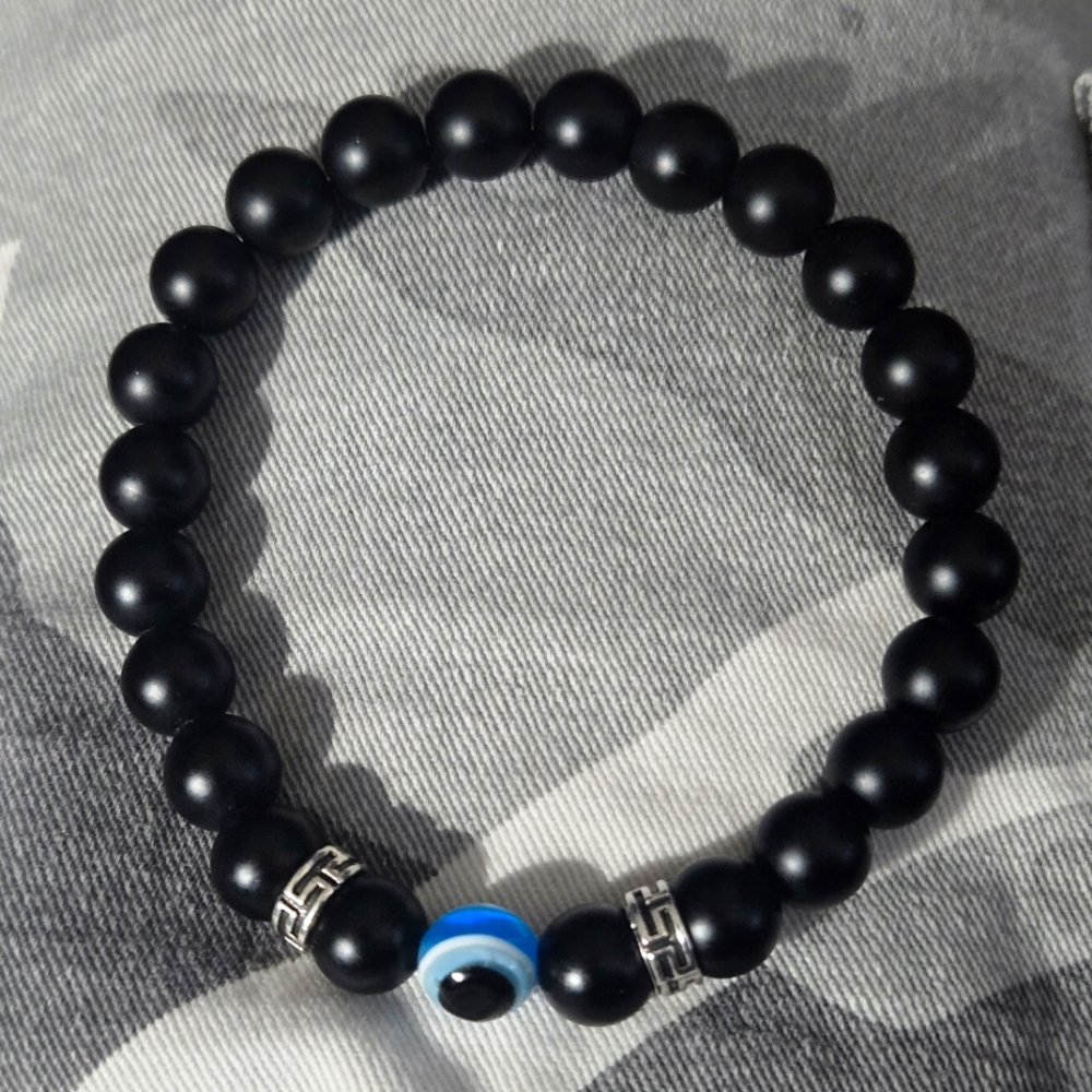 Black Smooth Onyx And Light Blue Evil Eye Beads With Silver Accents.